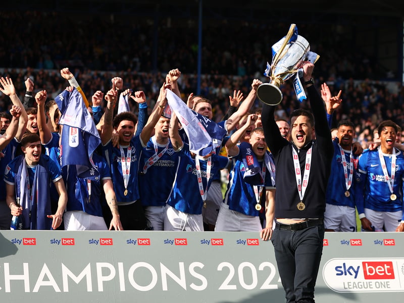 The celebrations are underway as John Mousinho lifts the trophy against Wigan.
