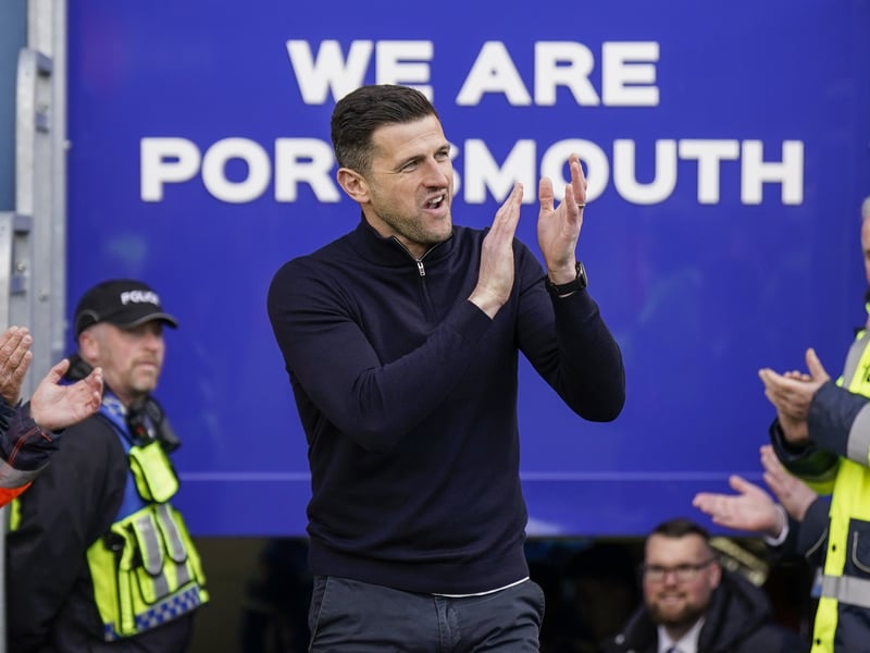 John Mousinho is welcomed to the pitch against Wigan.