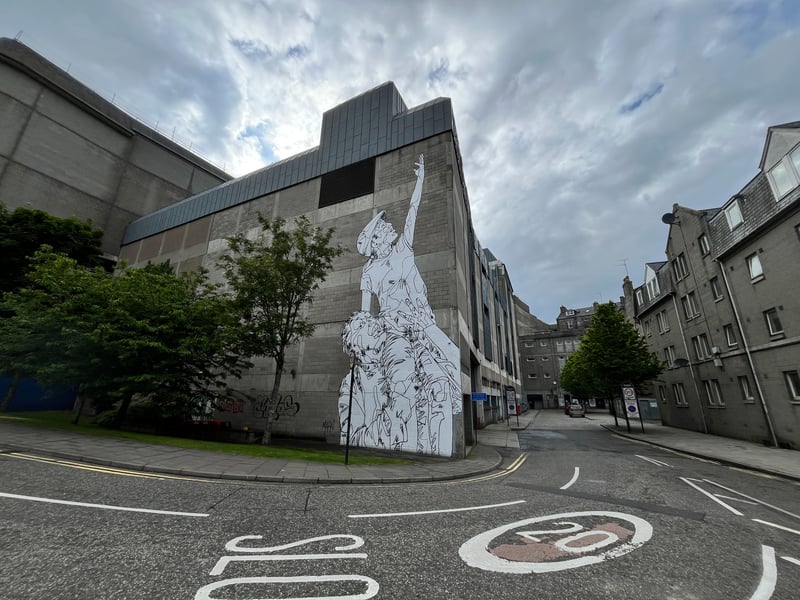 Almost like a paste up piece of street art, Mahn Kloix's work demonstrates "Living Heritage", the theme of Nuart Aberdeen 2024, particularly well with this piece which shows the older generation lifting up the younger.