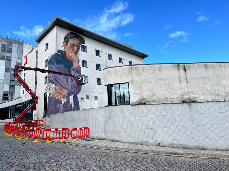 Case Maclaim's 2024 Nuart Aberdeen installation peers thoughtfully over Shiprow, which acted as a hub for this year's festival. The newspaper clutched in the figure's hand even references another work from this year's festival, with lines from the poetry seen in Know Hope's Woolmanhill piece.