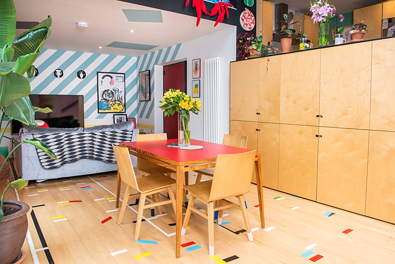 The couple have created a one-of-a-kind family home with a unique personal style including reusing the floor from a school gymnasium in the dining area.