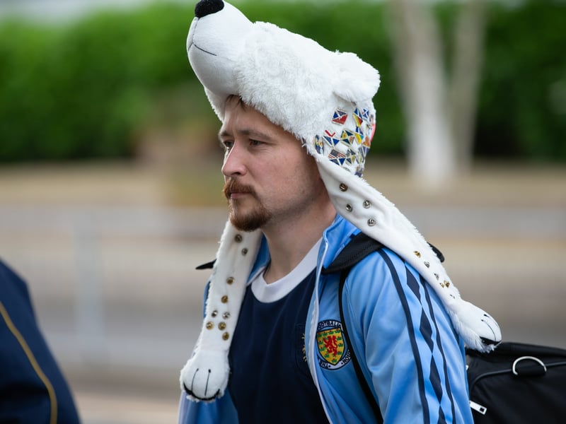 Complete with a retro Scotland tracksuit top, he has taken a one of a kind hat with him to Germany.