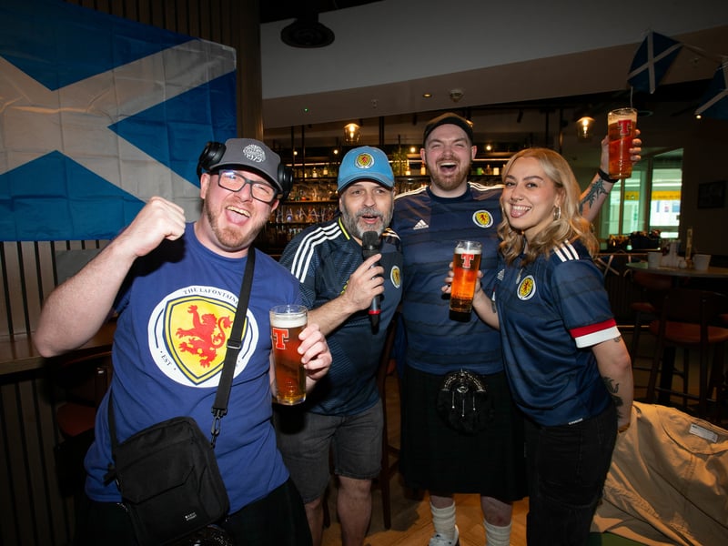 Fans share a drink ahead of their flight to Germany