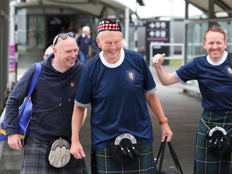 Smiles all around as three Scotland fans get ready to board.