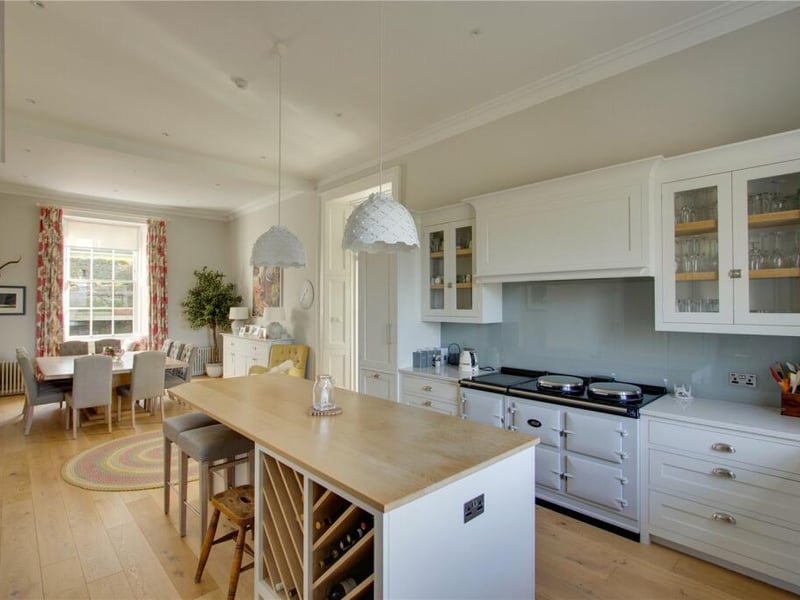 The main family hub is the Murray & Murray kitchen to the rear of the property, which offers a dining space, electric Aga, and access to the orangery.