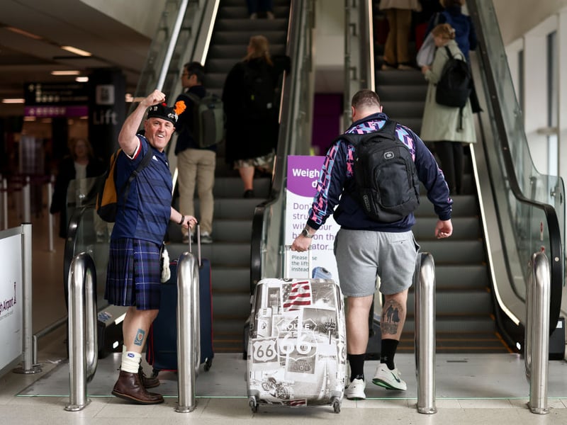 Scotland fans head to the departure lounge at Glasgow airport.