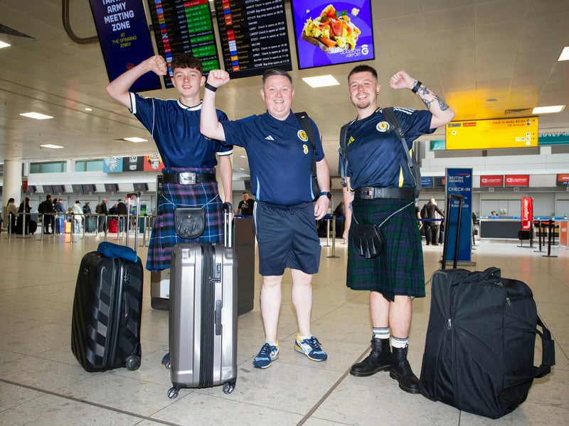 These three fans get ready head to Germany from Glasgow Airport.