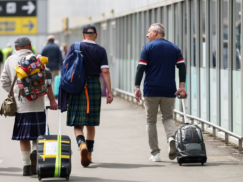 A trio of Scotland fans head into the airport ready to jet off to Germany.