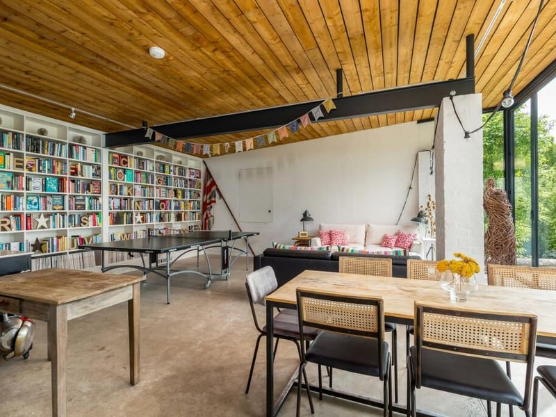 The sizeable garden building has space for dining, sitting and a table tennis set. 
