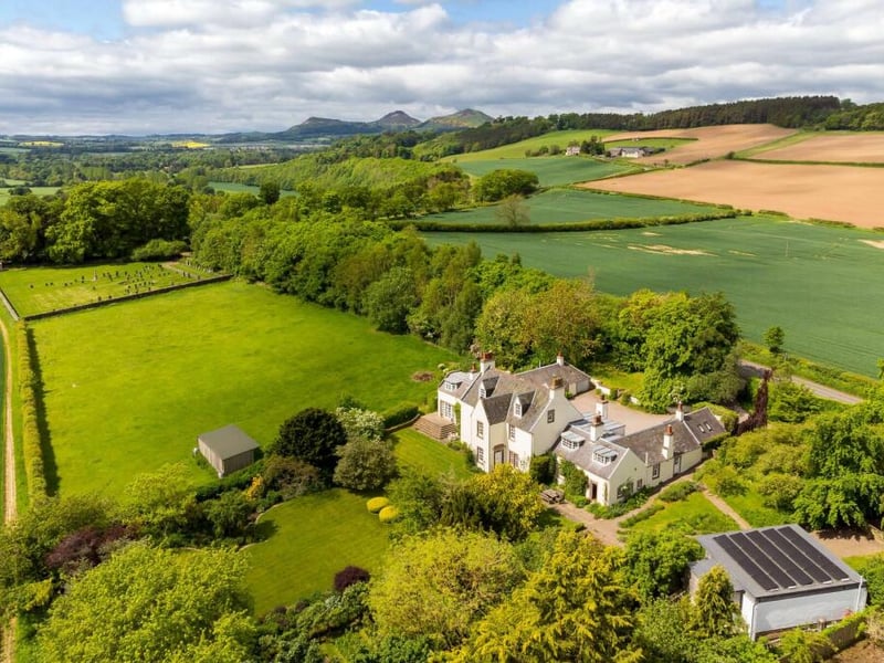 The house sits in beautiful gardens, consisting of around 1.26 acres, with large areas of lawn surrounded by mature borders and trees. There is a kitchen garden as well as various terraces.