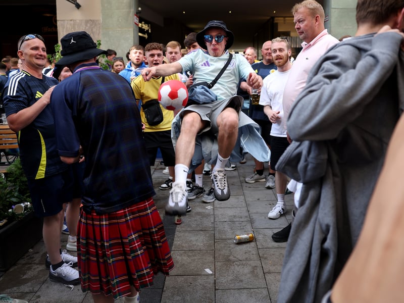 One Scotland fan tries a bicycle kick in the main square.