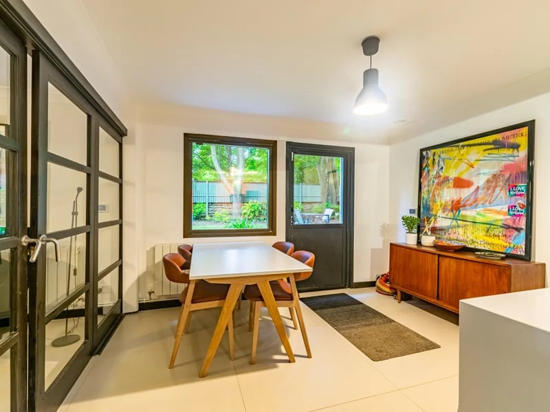 The downstairs rooms are airy with abundant natural light from large windows.
