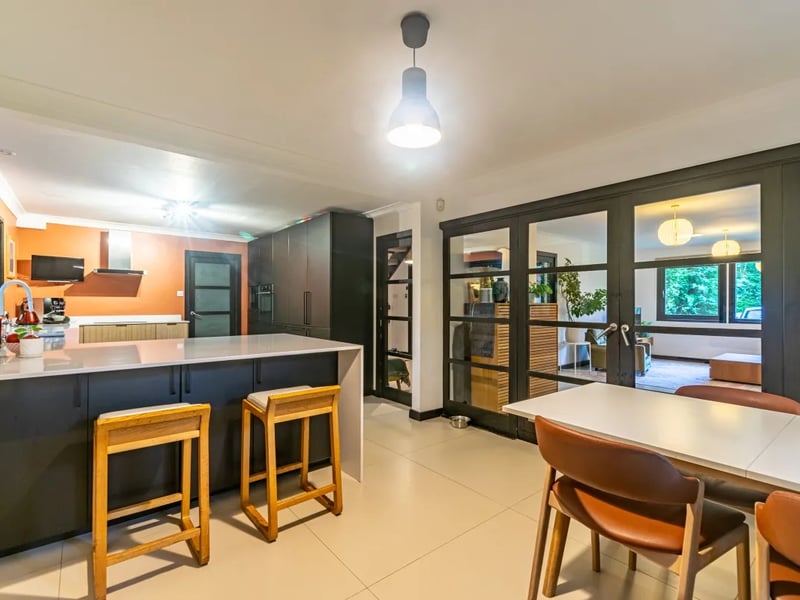 The kitchen provides access to the utility room and internal entry to the double garage.