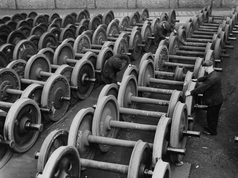 Checking the coach wheels at the LMS works at Saint Rollox, Glasgow, in preparation for the busy summer season. Glasgow produced parts for coaches, locomotives and tractors at the Massey Ferguson factory.