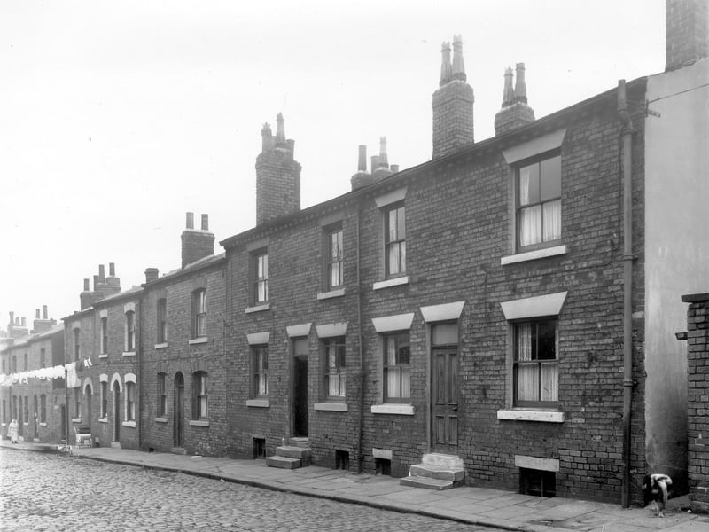  Long view of Lincoln Street showing number 21 on the right (numbers descend in an odds sequence). Far right is a narrow passage way through to Lincoln Field Row. These are double fronted, back to back terraced houses, destined for demolition, now the site of Primrose High School. Pictured in October 1958.