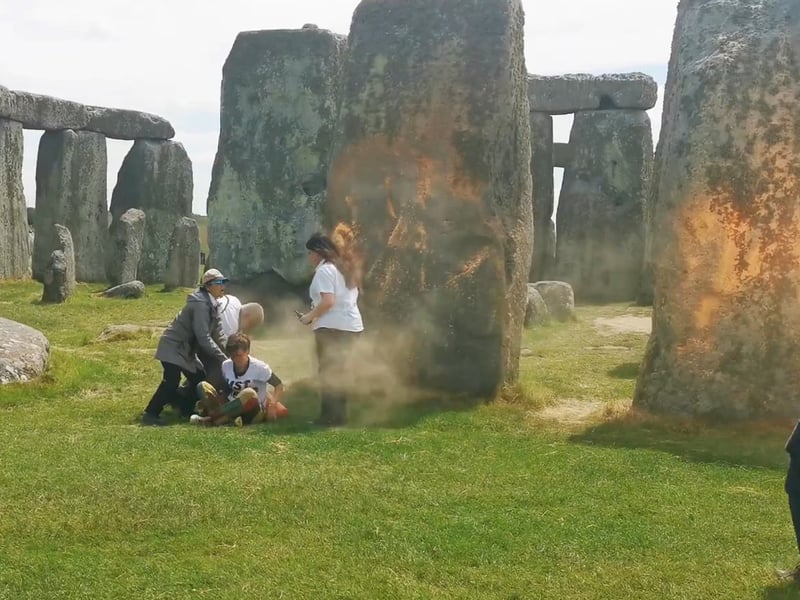 Protesters are confronted following the demonstration at Stonehenge. Members of the public were heard shouting “no” and running to intervene as the campaigners, named by the group as Rajan Naidu, 73, and Niamh Lynch, 21, ran up to the stone circle on Wednesday