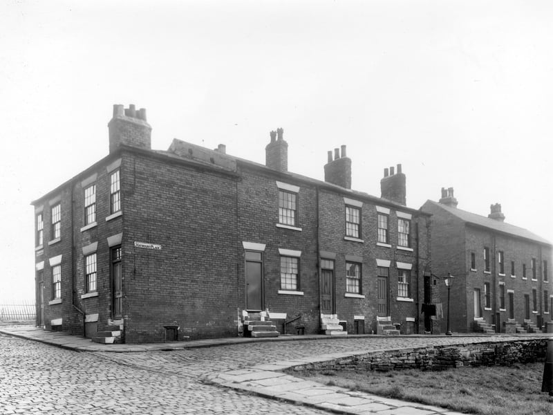 Derelict property in Lincoln Street. Fronting on to Cherry Row on the left is number 24 Cherry Row. This has been shop premises but is now unoccupied and dilapidated. It has obviously been a grocers most recently, indicated by the large advertising hoardings for 'Omo' washing powder and Rowntrees jelly but was once a pawnbrokers.