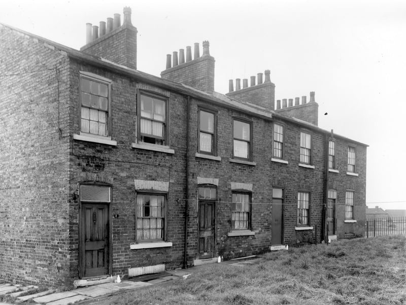 Back to back terraced houses in Hill Place. Beyond this street was the boundary of the clay pit. In the background can be seen the buildings of Longclose Works. The locality was known as Newtown. Pictured in October 1958.