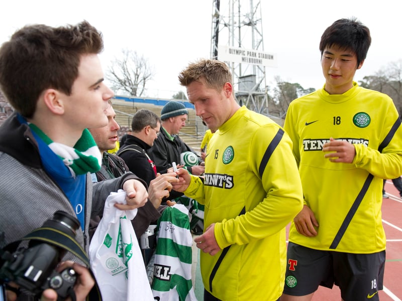 Celtic players Kris Commons and Ki sign autographs for fans during the 2011 tour of Australia.