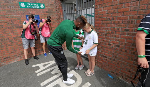 Celtic's Moussa Dembele signs a young fan's shirt ahead of the pre-season friendly match against Shamrock Rovers at the Tallaght Stadium.