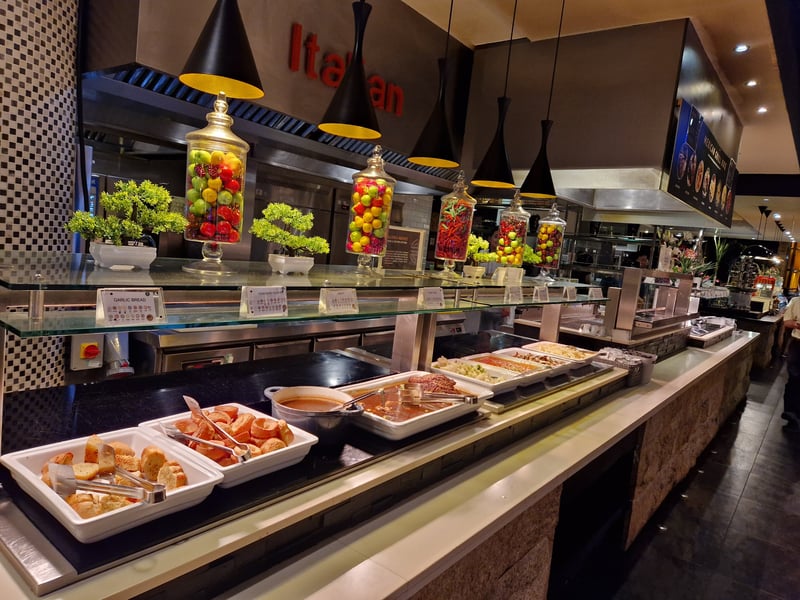 Peel your eyes away from pretty glass jars filled with multi-coloured ornaments. Focus instead on rows of steaming hot food, here is the Italian counter featuring pizza, bread, pasta and more.