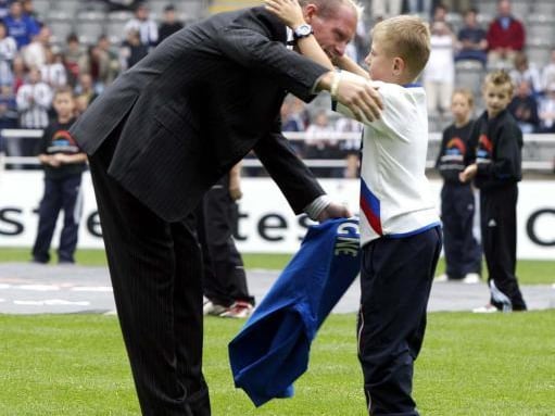 Ex-Rangers player Paul Gascoigne gives young fan McCauley Gilchrist from Glasgow a hug during the Newcastle Cup mini tournament at St James Park 2004.