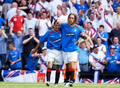 Dado Prso celebrates in front of the Rangers support during during the pre-season friendly match with Fulham in 2004.