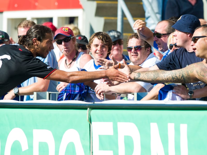 Rangers' Bilel Mohsni exchanges handshakes with a supporter after the final whistle following the game with FC Emmen in 2013.