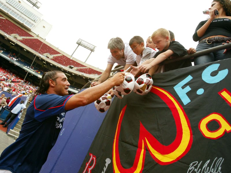 Rangers' Lorenzo Amoruso meets eager fans in Giants Stadium in New York following the team's game against River Plate in 2002.