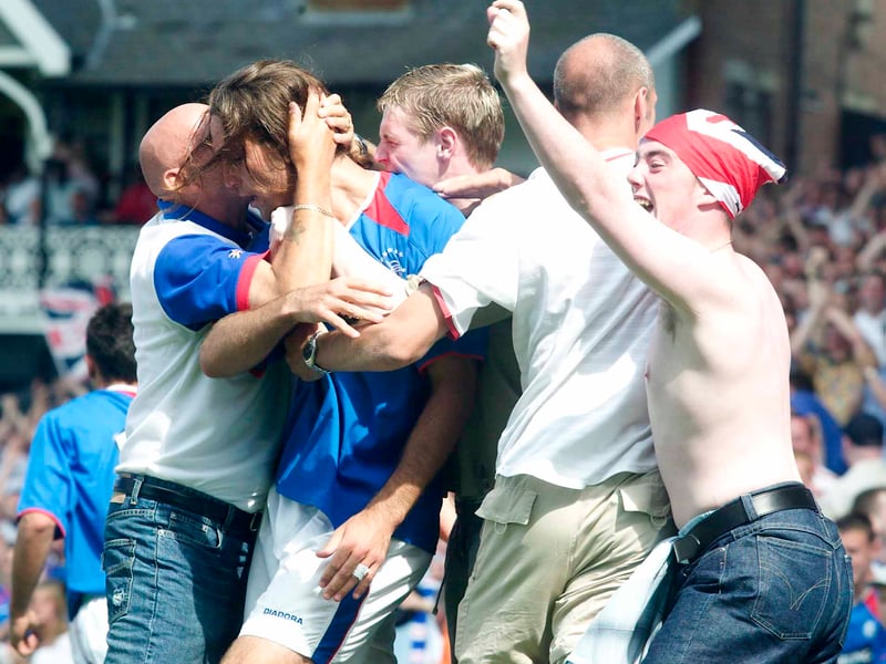 Dado Prso is mobbed by delirious Rangers fans after scoring the winner against Fulham in pre-season 2021.