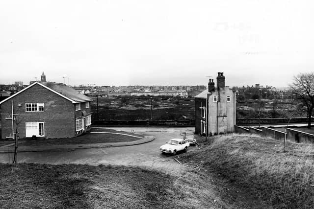 The junction of Oldfield Lane and Elmfield Grove, with houses at either side. To the right is the edge of Wortley Recreation Ground. Pictured in January 1983.