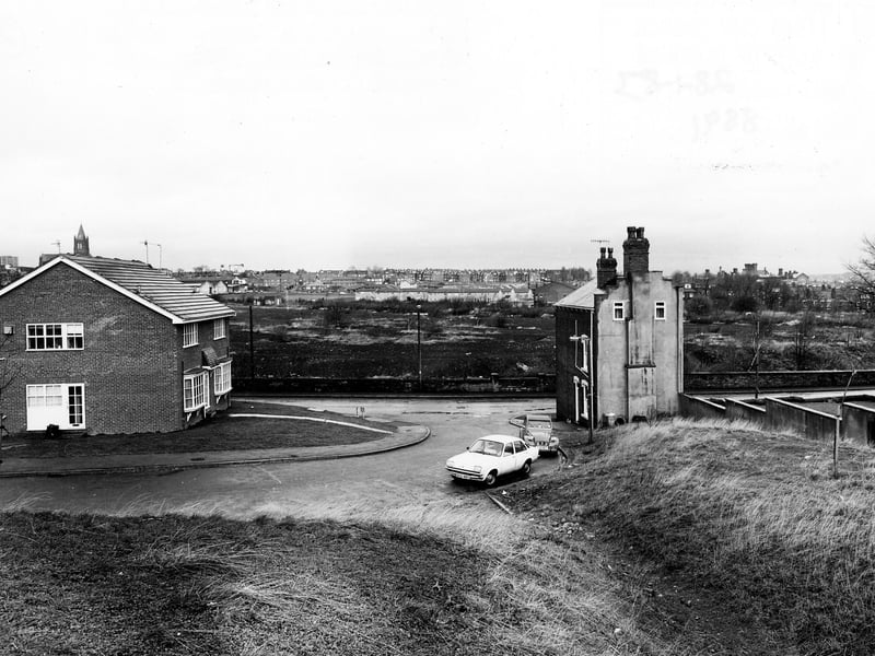 The junction of Oldfield Lane and Elmfield Grove, with houses at either side. To the right is the edge of Wortley Recreation Ground. Pictured in January 1983.