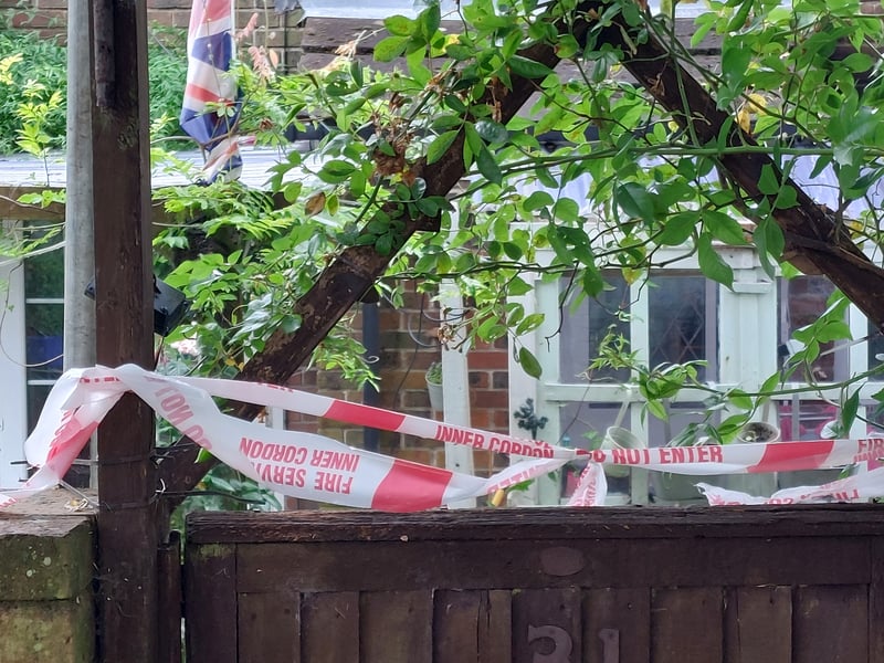 The property remains taped off while the damage is assessed.