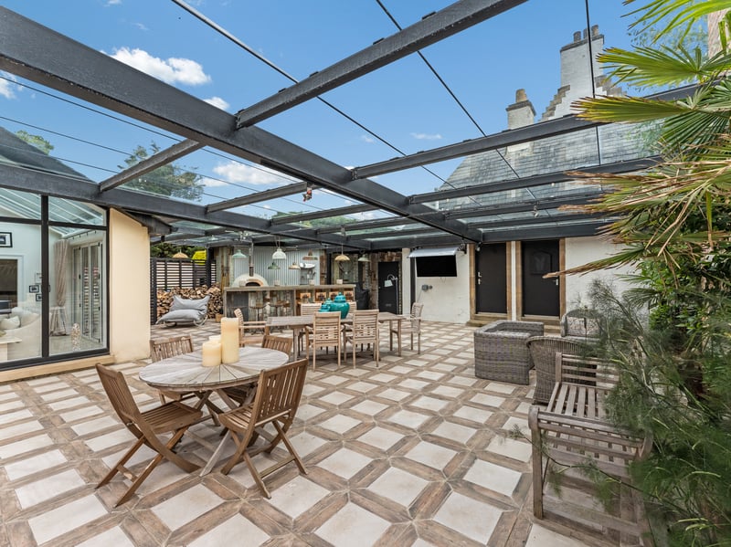 The outside dining area covers 1200 square ft, with a fridge, outdoor TV, and pizza oven.