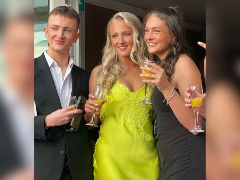 A trio pose with their celebratory drinks