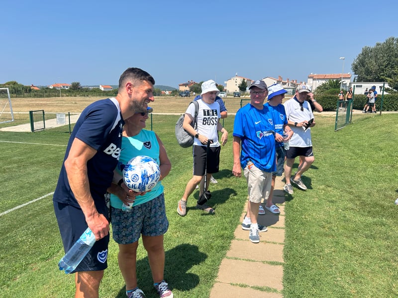 Pompey boss John Mousinho has his photo taken with a supporter