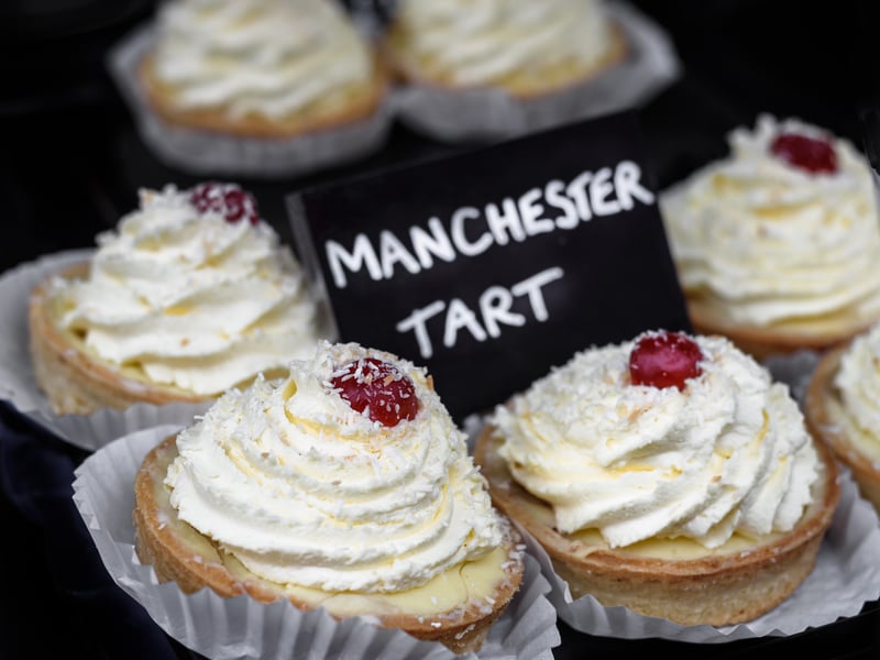 Manchester Tart is a classic dessert that has been enjoyed for centuries, after being created by British journalist Isabella Beeton. It is a baked tart made from a shortcrust pastry shell spread with raspberry jam, covered with custard filling and topped with coconut. (Photo: hubb67 - stock.adobe.com)