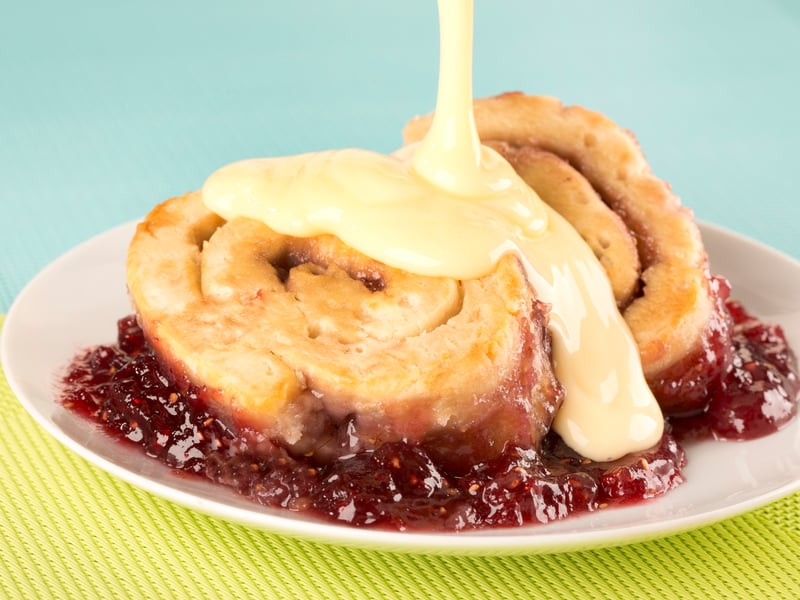 Jam roly-poly is a traditional British pudding which is made from a flat-rolled suet pudding spread with jam and then steamed or baked. It is usually served with custard. (Photo: cdkproductions - stock.adobe.com)