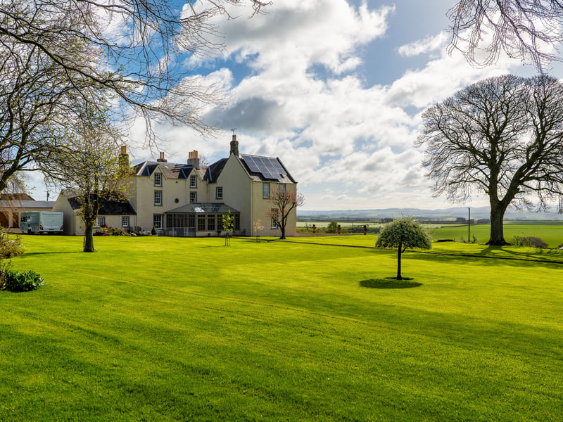 As well as the all-weather tennis court, there is a summer house and croquet lawn. Two private driveways, mature hedges, trees and shrubbery, with a west-facing patio. The property’s two-acre paddock has a building which could be used as stables. Contact Paton and Co.