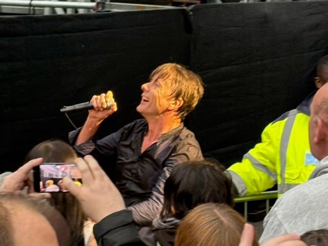 Suede's Brett Anderson sings to the front row.