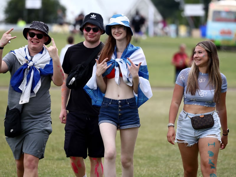 Some patriotic music fans arrive for the Saturday at Glasgow Green.