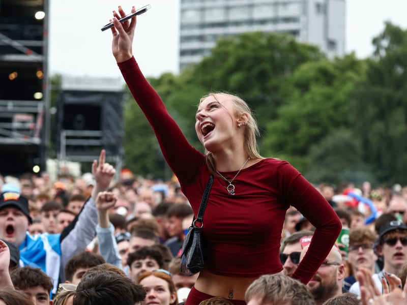A fan captures some of Saturday's action on her mobile phone.