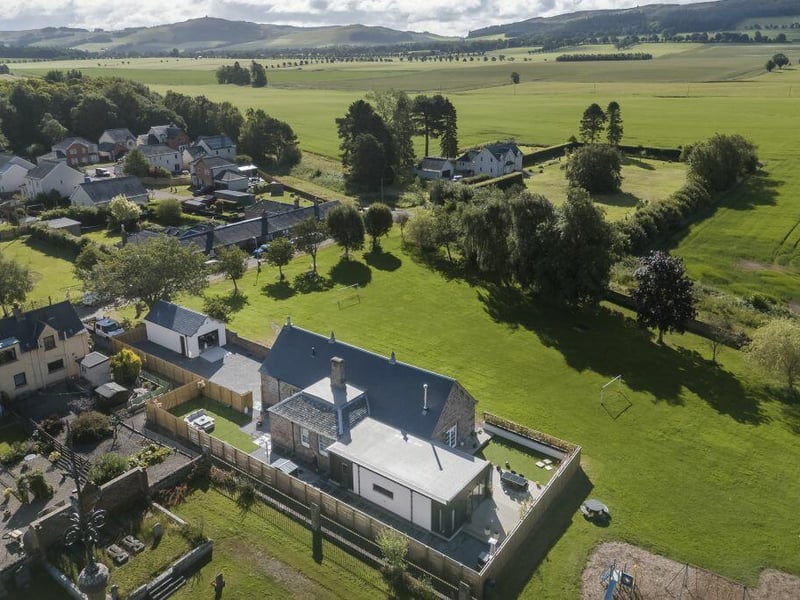 Outside are landscaped garden grounds with decking, a gated driveway, parking, plus a detached garage. The house looks onto the village kirk and enjoys spectacular south-facing countryside views. Contact Gilson Gray