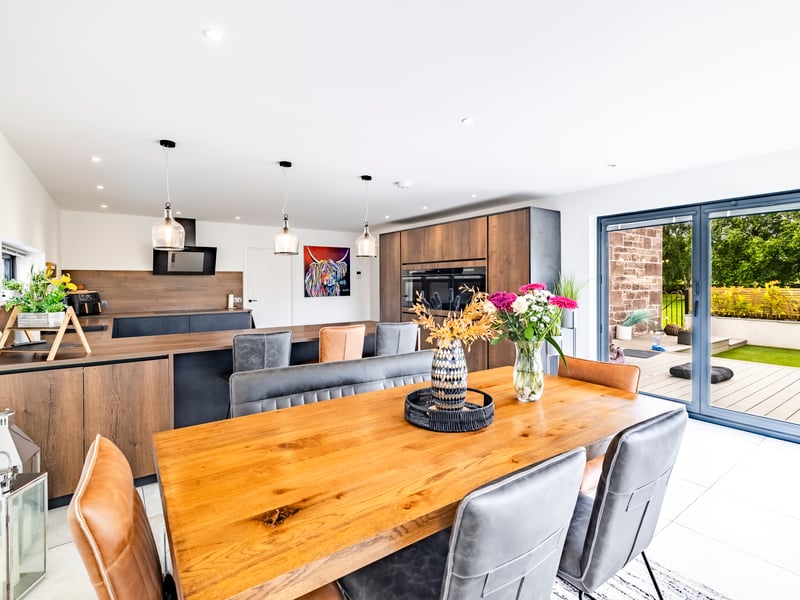 The contemporary dining-kitchen has bi-fold doors to the decking.