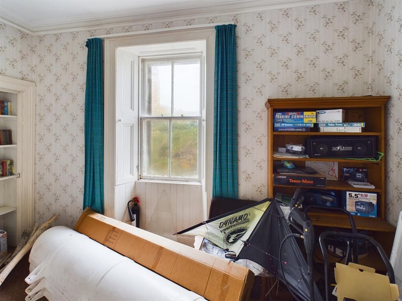 One of the bedrooms features a build in bookshelf.