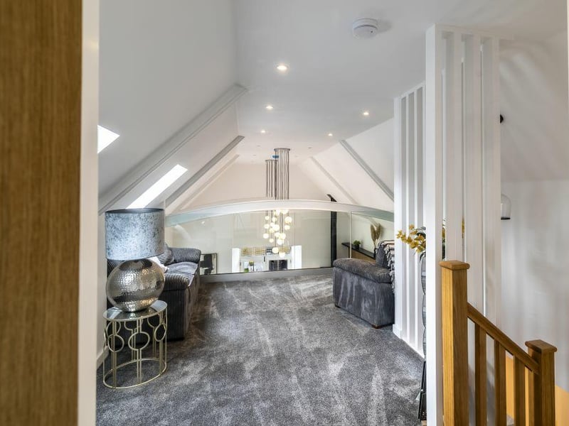 The mezzanine sitting room overlooks the living space below.