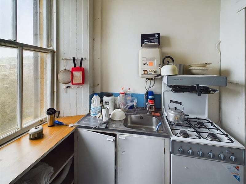 The compact kitchen is also in need of an update