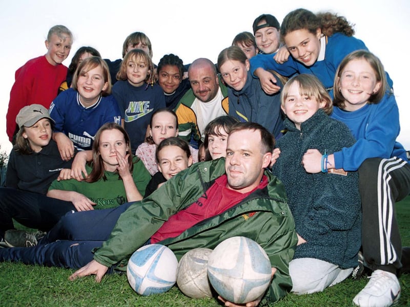 Coaches Dave Medley, (horizontal), and John Cockroft (in the thick of things) with members of the new age group for Middleton Marauders girls RL club. Pictured in October 2000.