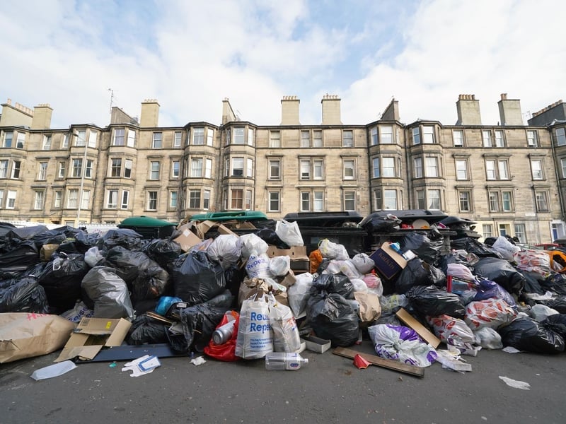 Piles of rubbish and overflowing bins are pictured outside a row of tenements in Edinburgh on the final day of the waste strikes in 2022