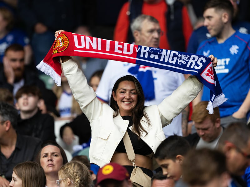 One fan shows off her commemorative scarf from the game at Murrayfield.